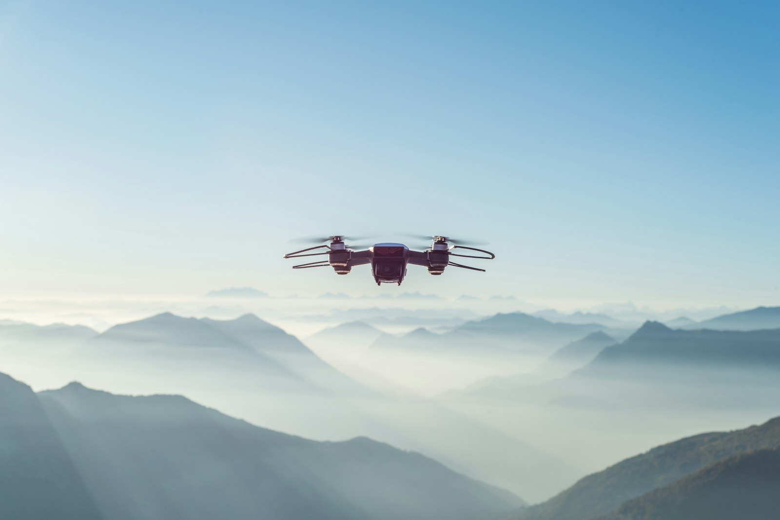 A survey drone flying above mountainous terrain
